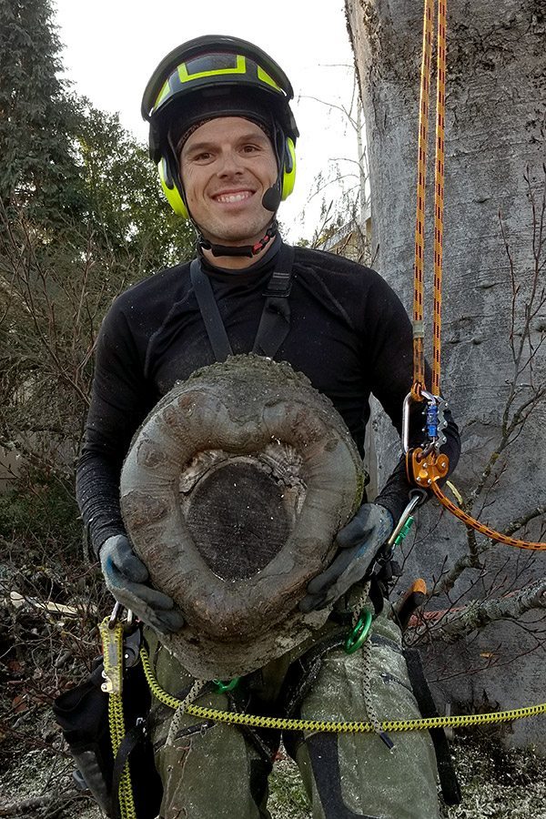 Arborist Tree Service Professional Jacob holding heart shaped stump